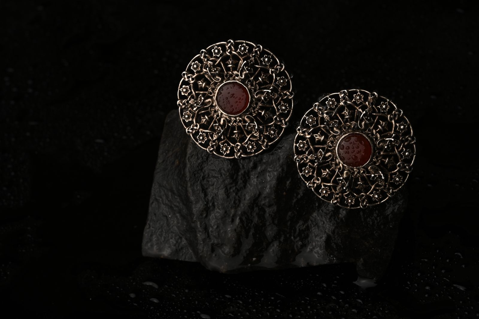 Layered brass earrings referencing sacred architecture