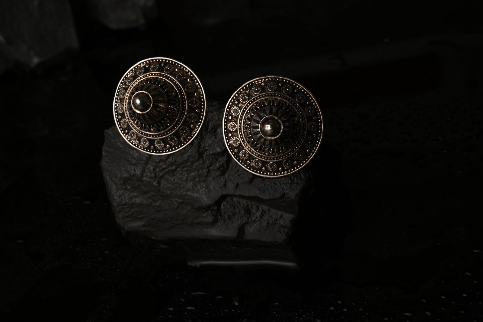 Ornate brass earrings rooted in Indian sculptural traditions